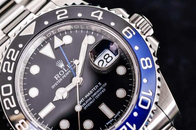 Close up Rolex GMT-Master II "Batman"40mm with blue-Black bezel Steel Ceramic Men's Wrist watch on black background.