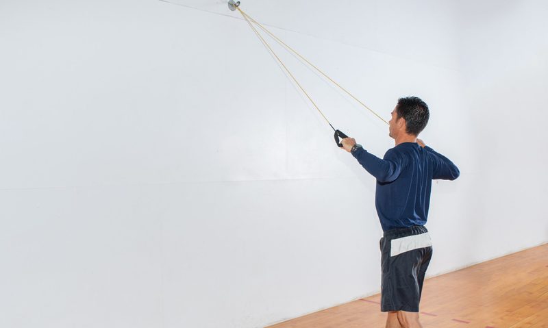 Man doing resistance band lat pulldowns at home