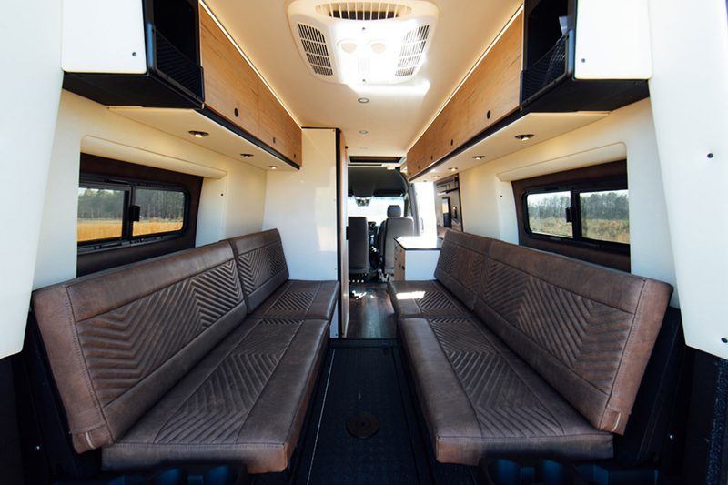 Convertible rear bedroom/lounge inside Storyteller Overland's Crew Mode adventure van.