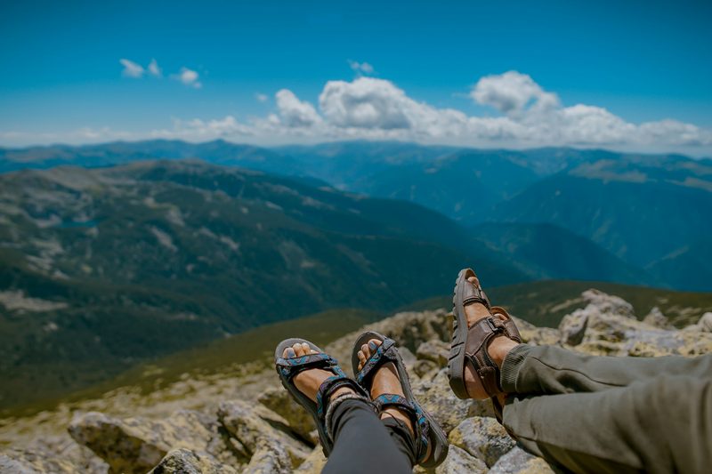 Couple sitting at a view wearing hiking sandals