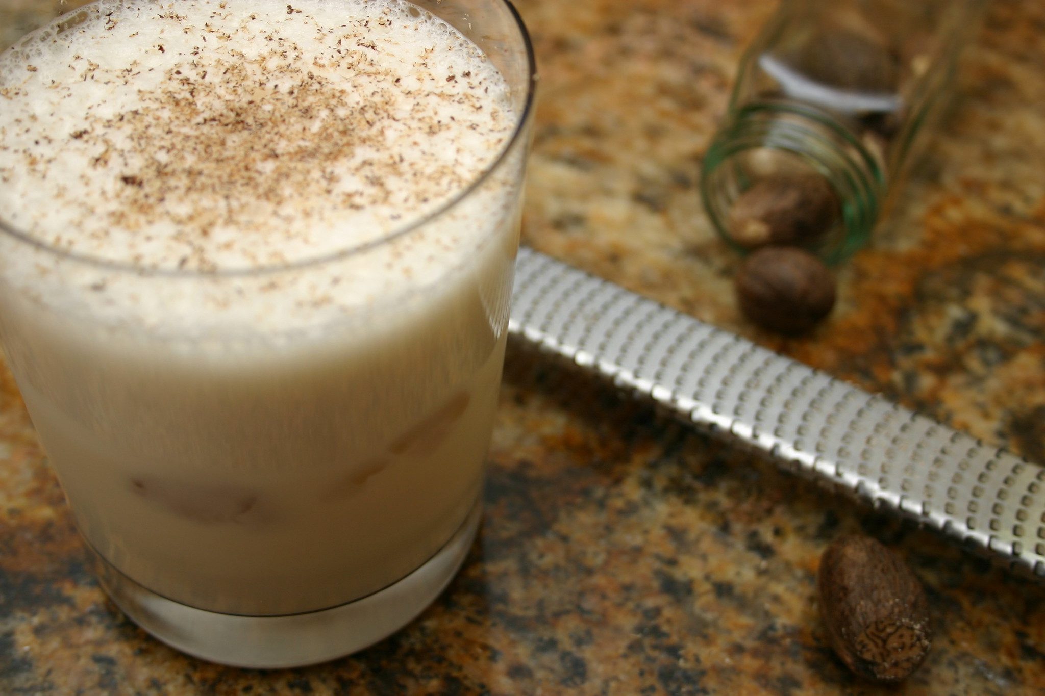 A Brandy punch with a zester on a table