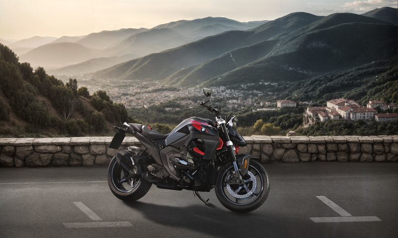 BMW R 1300 R in hilltop parking space overlooking a city in a valley.