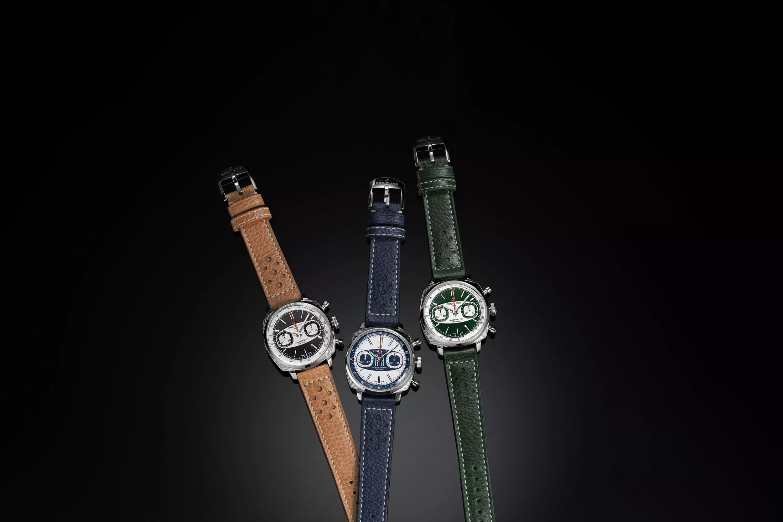 Three Breitling Top Time chronograph on dark background