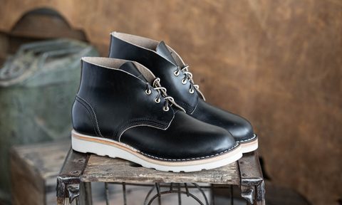 black chukka boot on metal box