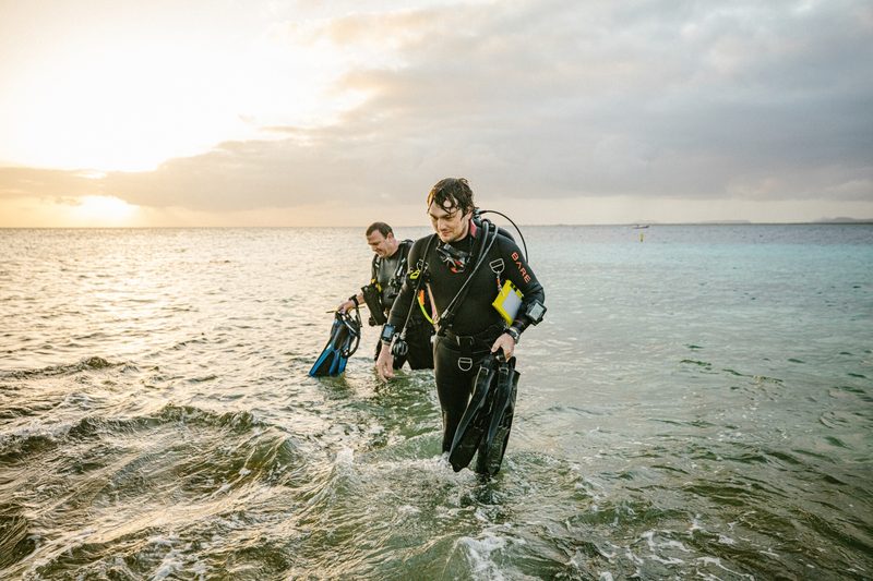 Divers walking out of the water
