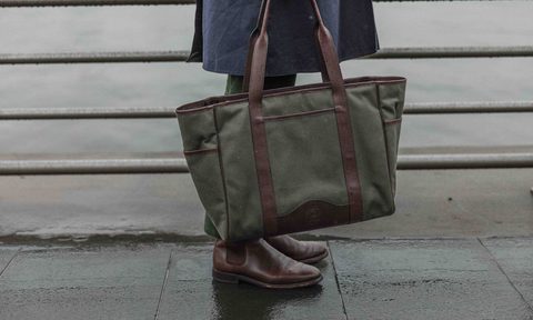 The Ghurka x David Coggins Field Tote in olive twill with brown leather straps and trim.