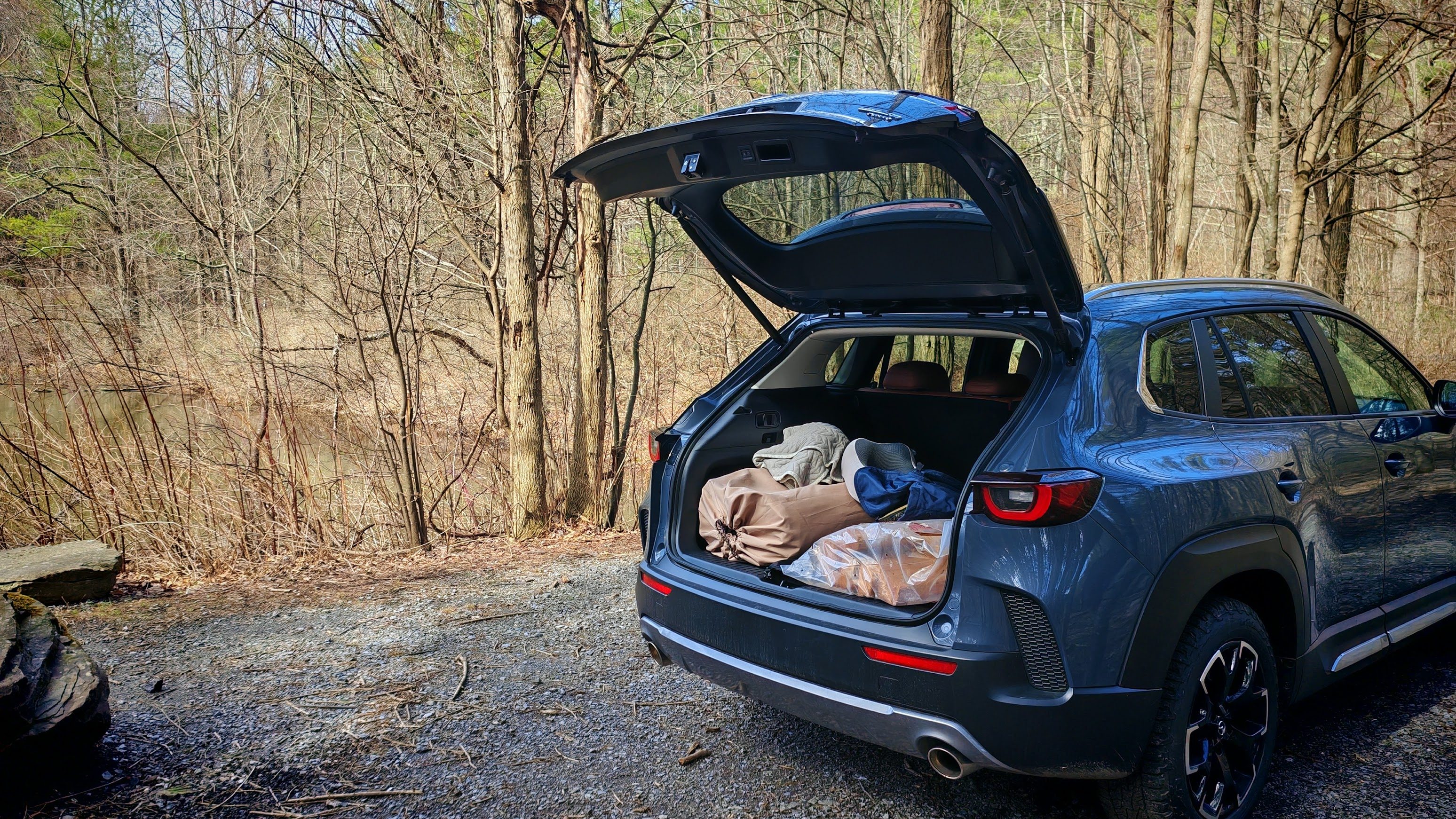 The trunk of a CX-50 with camping supplies inside