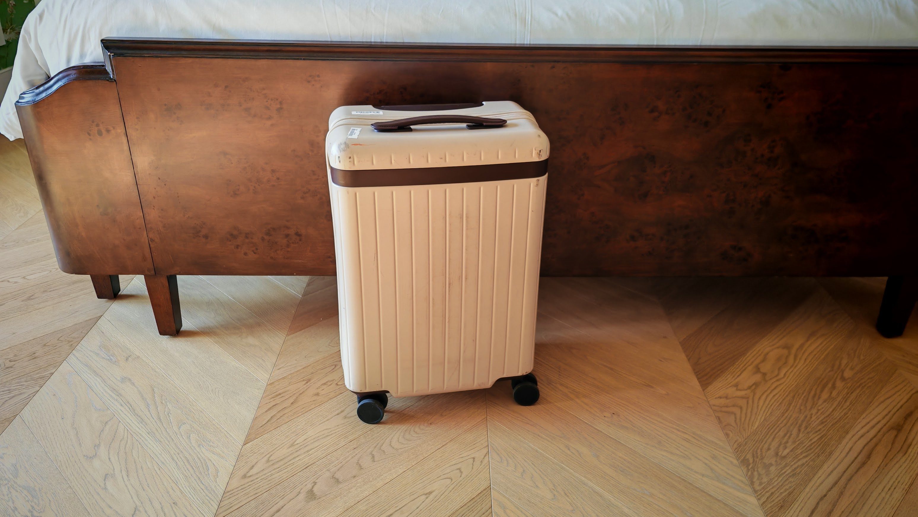Carl Friedrick core carry on near a bed in a hotel room