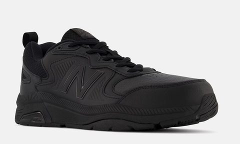 The New Balance MX857v3 Slip Resistant training shoes on a gray background.