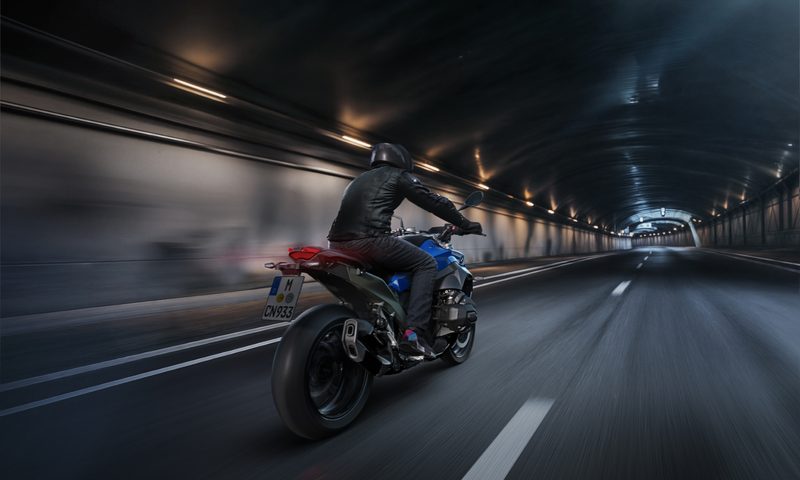 Rider on a BMW R 1300 R driving through a highway tunnel.