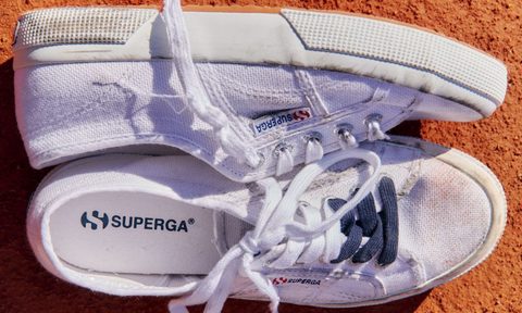 white superga sneakers on tennis court