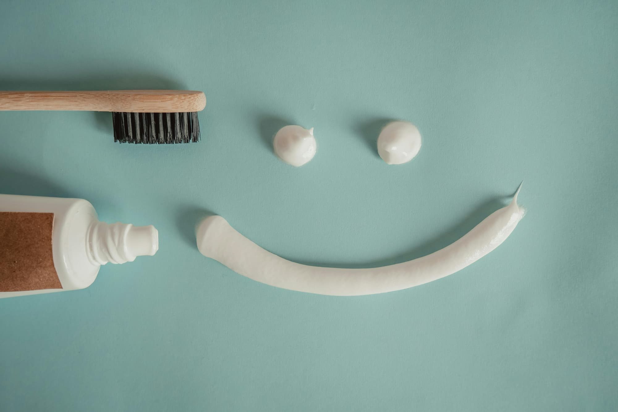 bamboo toothbrush and a smiley face made out of toothpaste