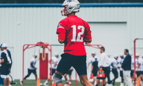Tom Brady playing football.