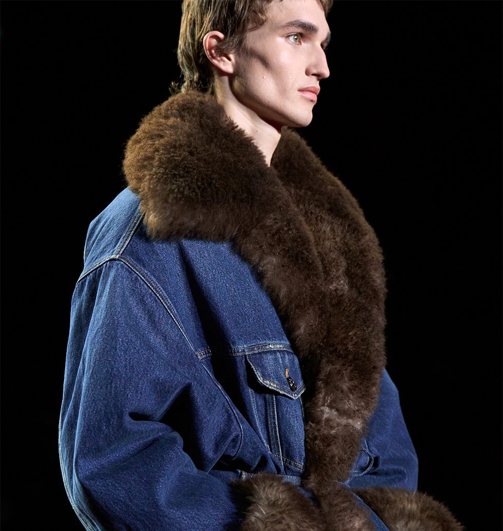 Model wearing denim jacket with shearling collar