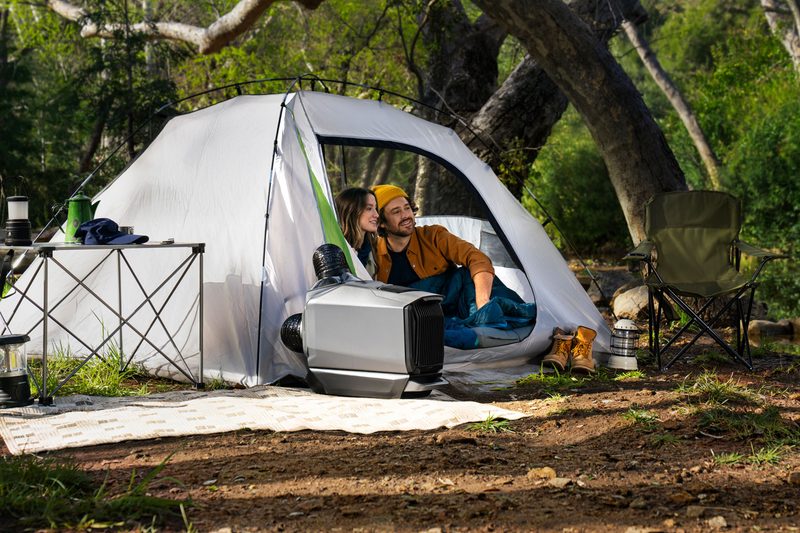 A couple tent camping with an EcoFlow Wave 3 portable air conditioner.
