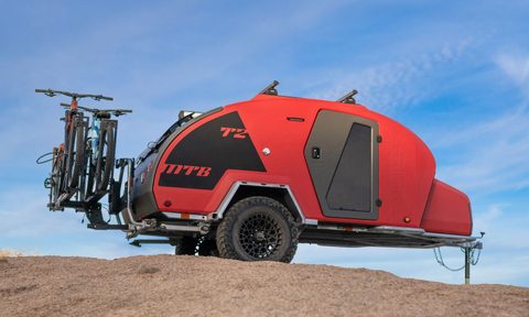 Side view of an Escapod TOPO2 MTB travel trailer parked on a hill.