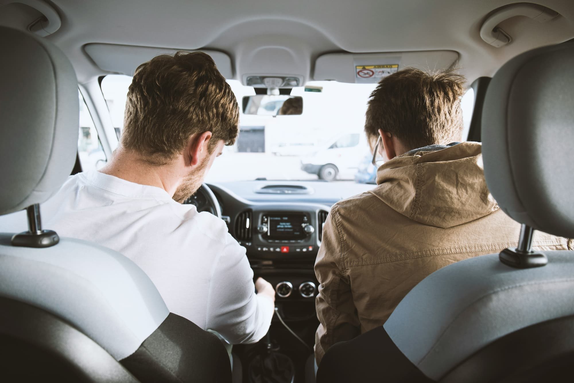 two men sitting inside car
