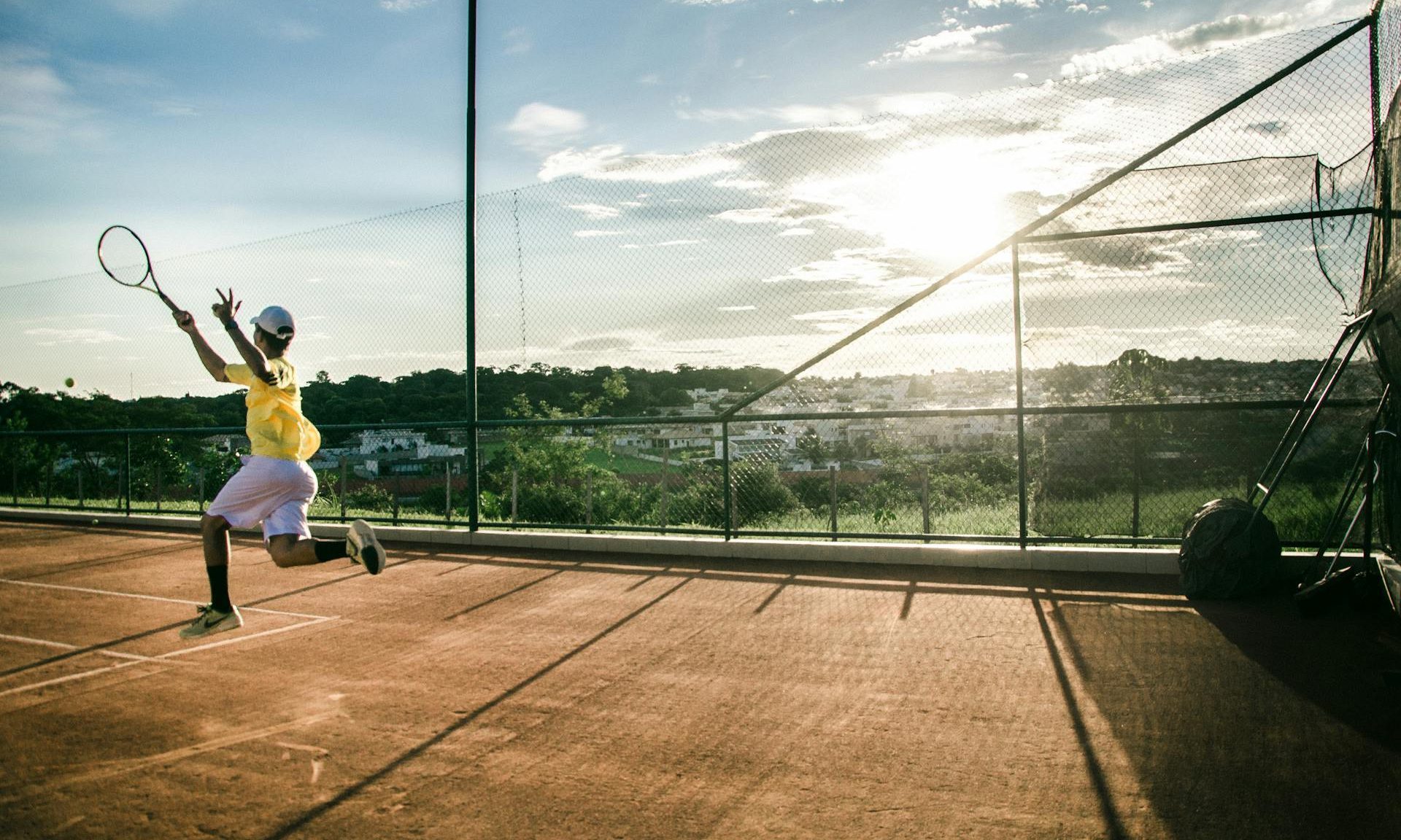 man playing tennis active
