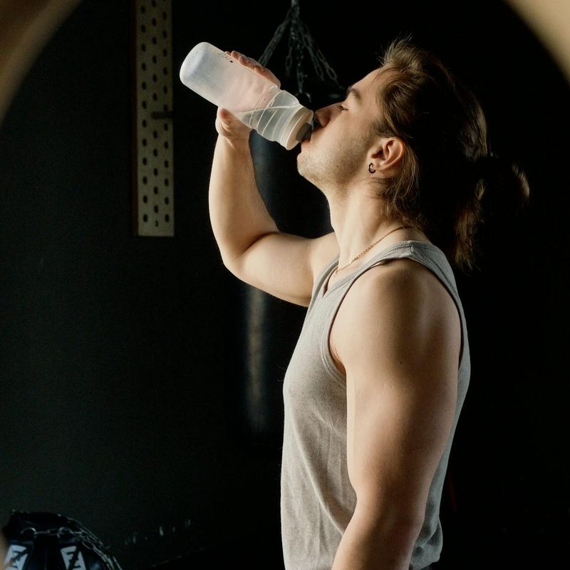 Man drinking water gymnastic ring