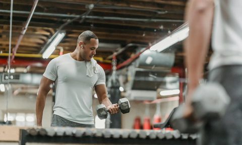 man bicep curl gym lifting weights