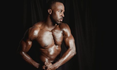 man flexing muscles strong arms