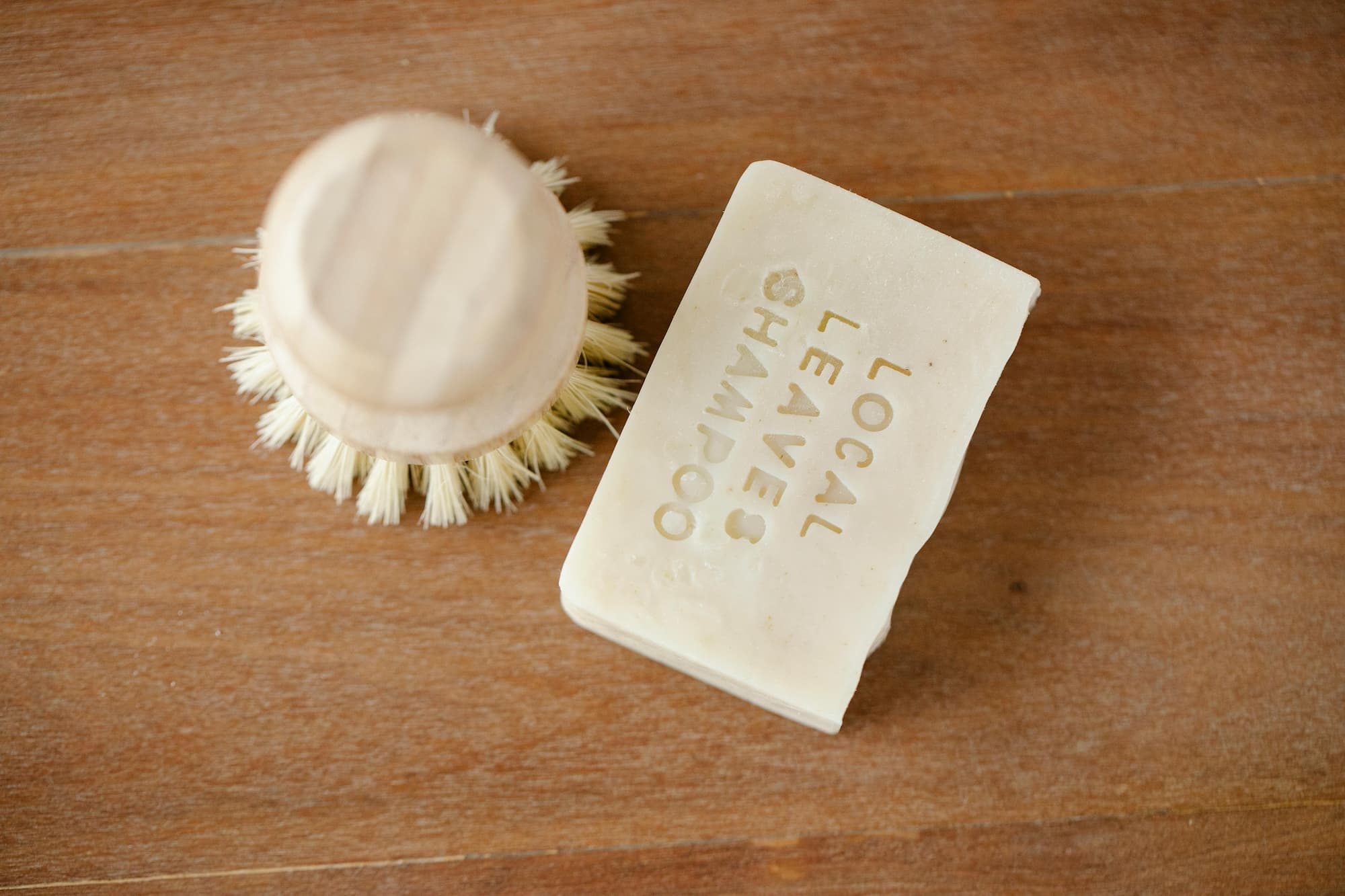 skincare brush next to solid shampoo bar