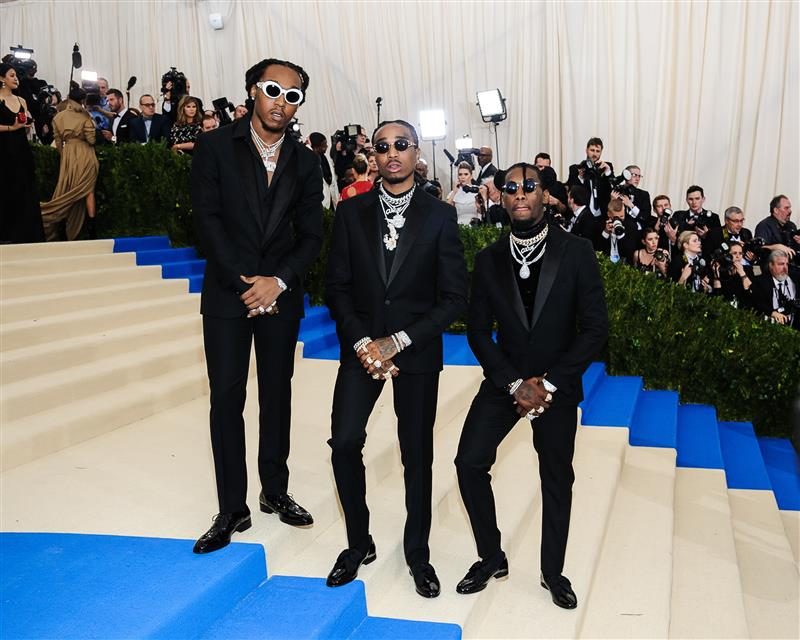 MIGOS attend Met Gala in matching black suits.