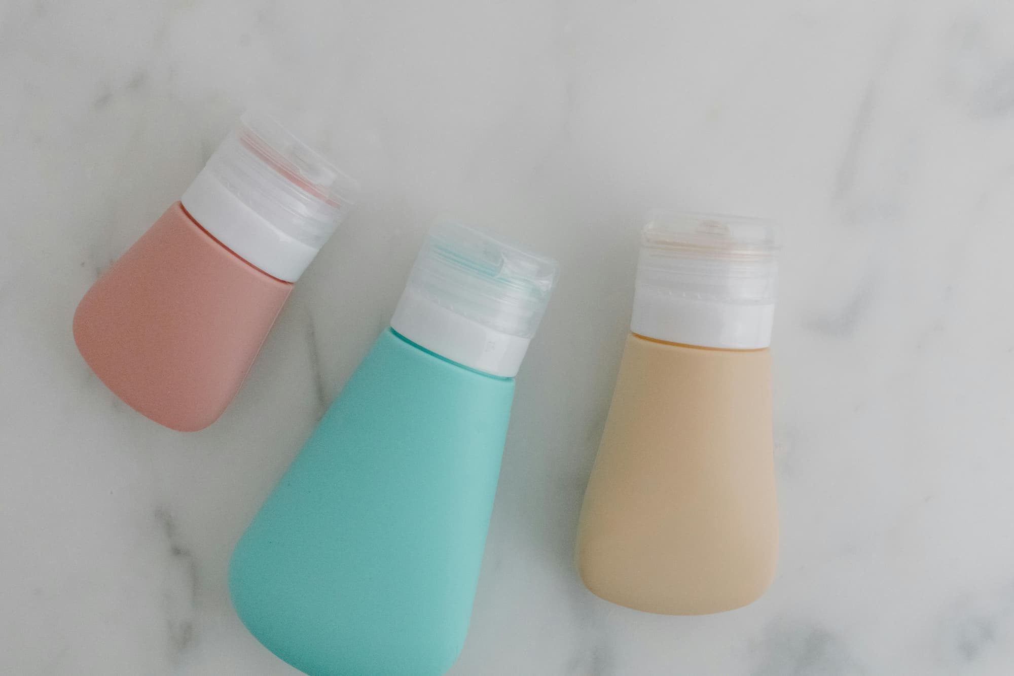 reusable silicone toiletry bottles on counter