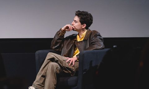 Timothee Chalamet sitting at a Q&A in New York City.