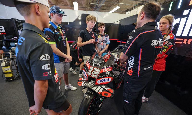 Aprilla representative talking with MotoAmerica Talent Cup racers.