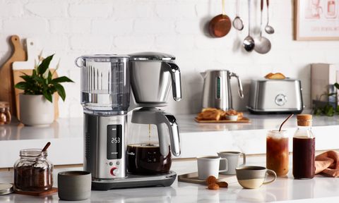 Breville Luxe Brewer with glass carafe on a kitchen counter.