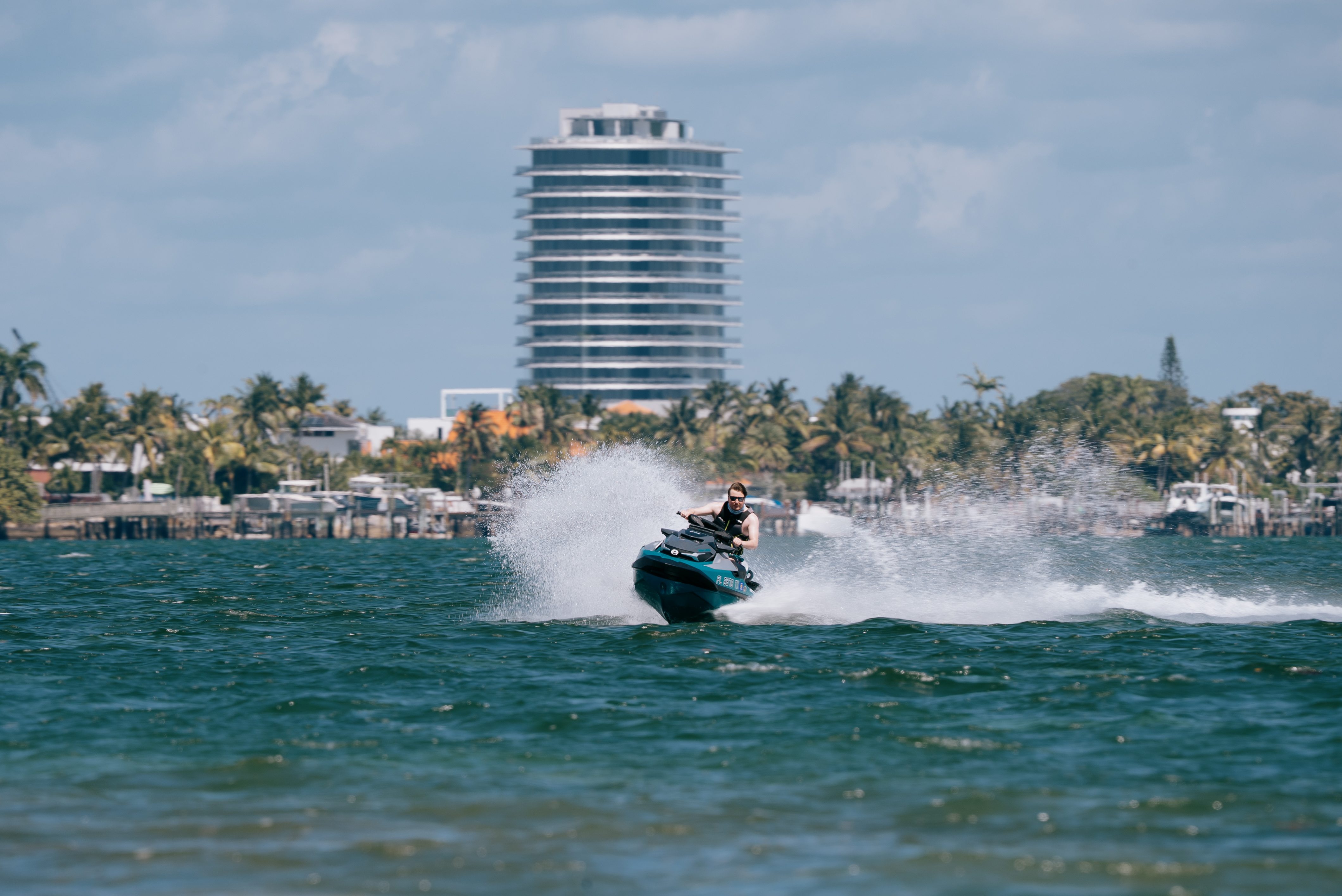 Man on a PWC with a miami skyscraper in the background