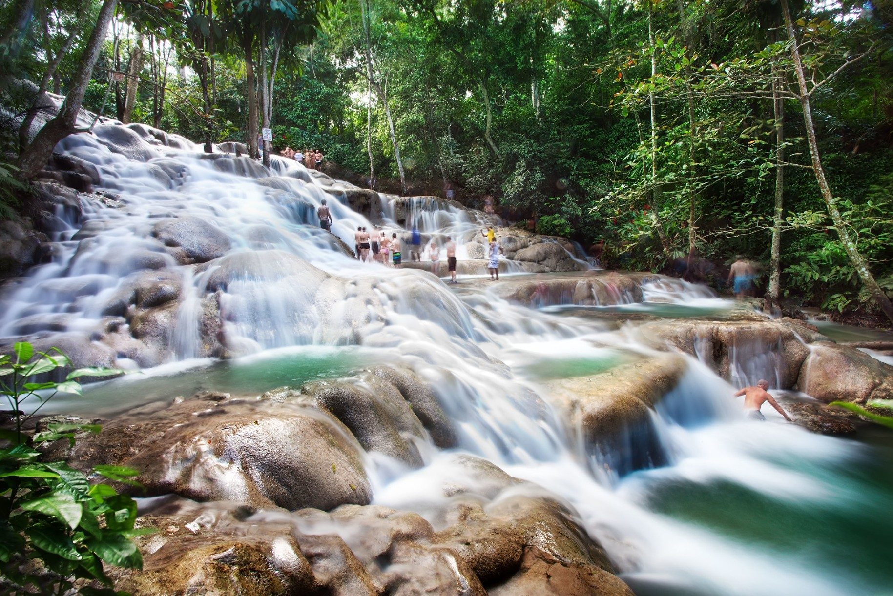 Waterfalls with tourists on a summer day in Jamaica
