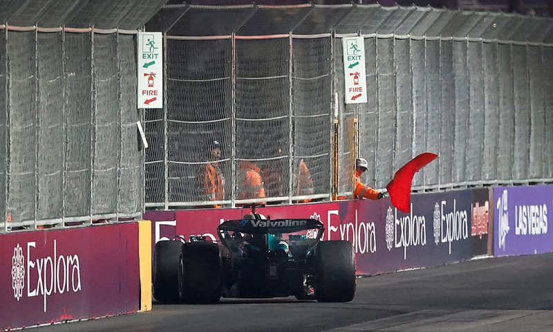 LVGP Marshalls waving a red flag after a race car hit the barriers.