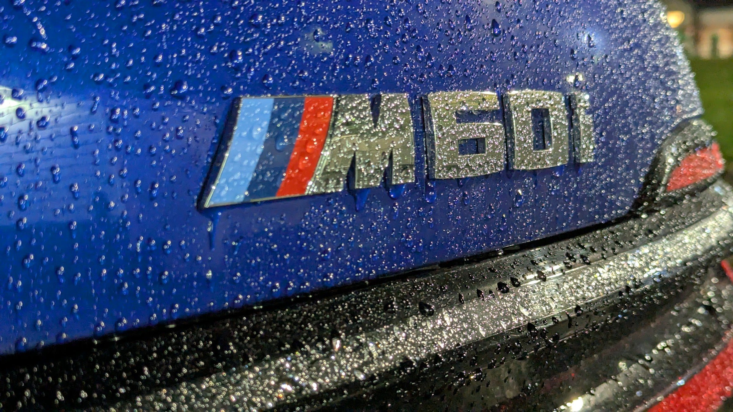 M60i badge with rain drops