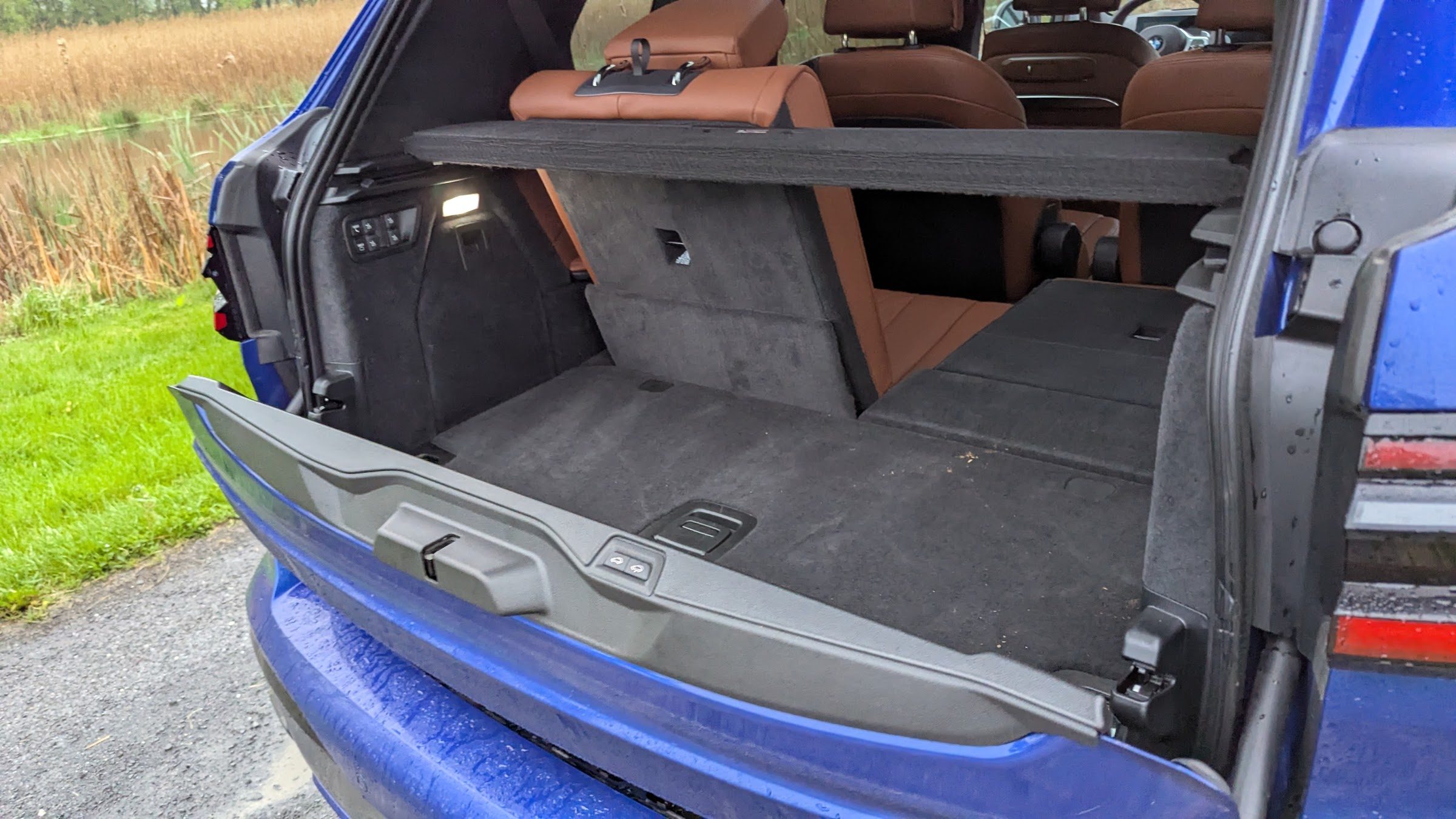 trunk space and rear seats of a a blue BMW X7 M60i