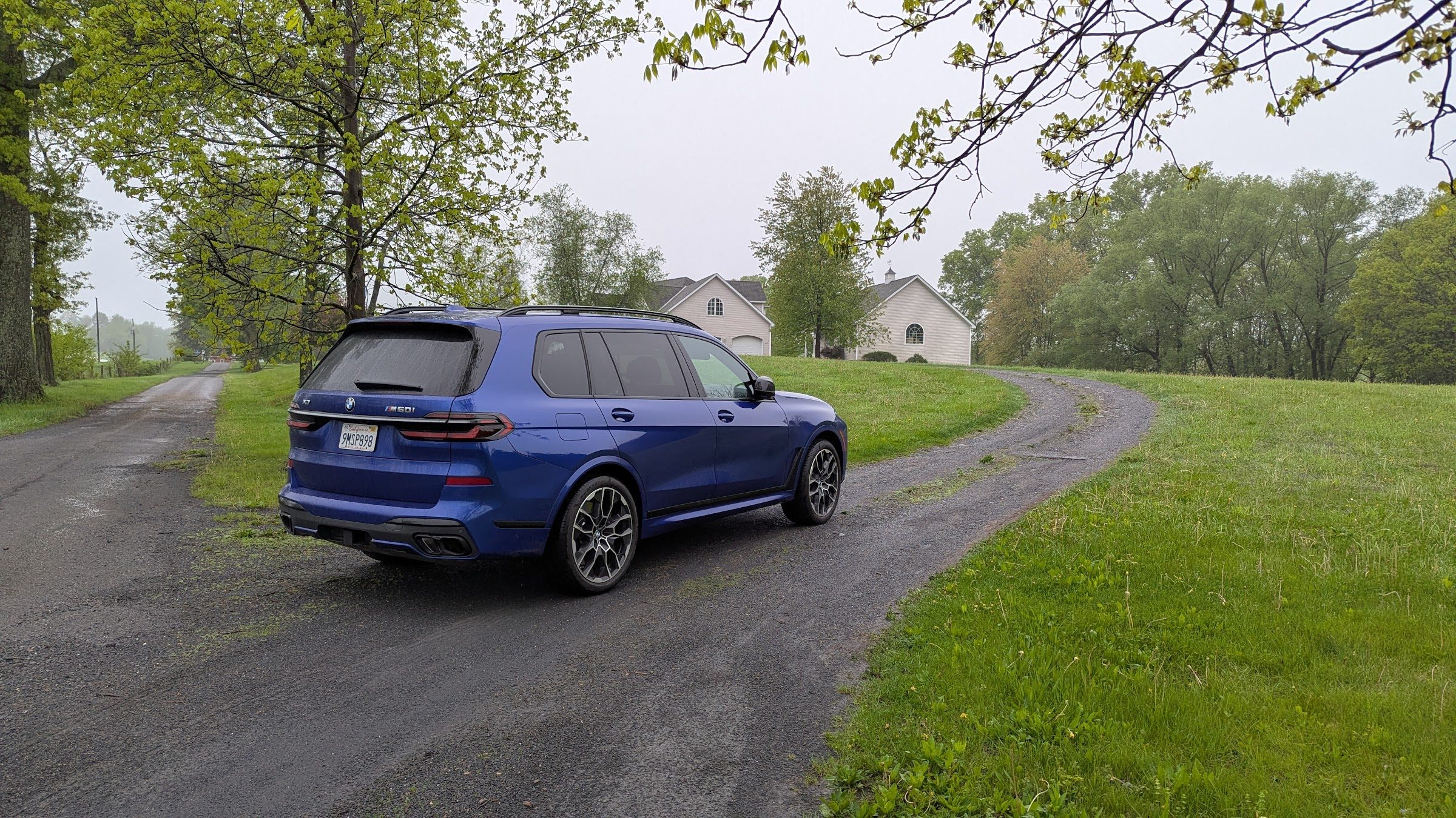 Rear 3/4 view of a a blue BMW X7 M60i