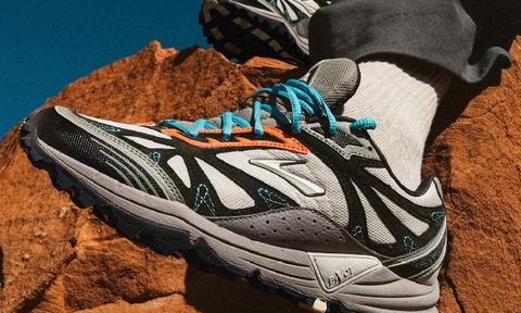 grey brooks running shoe on red rock