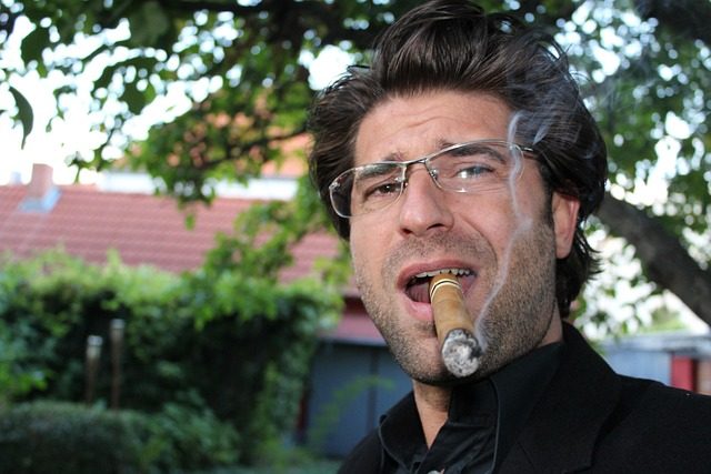 man clenching a cigar in his teeth