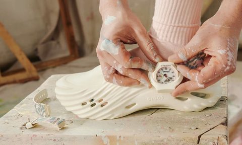 person adjusting g-shock casio watch on croc