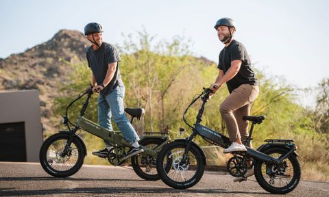 Two men riding Lectric XP4 folding electric bikes in a neighborhood.