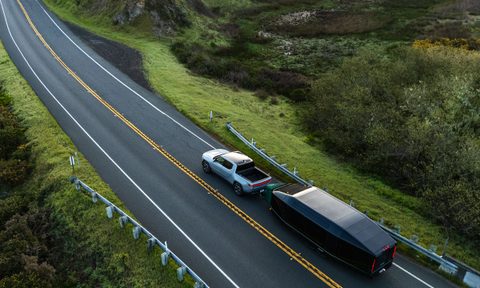 Aerial of a Rivian pickup truck towing a Lightship AE-1 all-electric travel trailer.