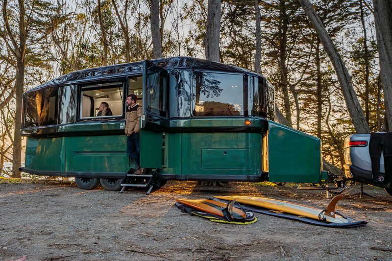 Young couple camping with a Lightship AE.1 Cosmos Edition all-electric travel trailer.