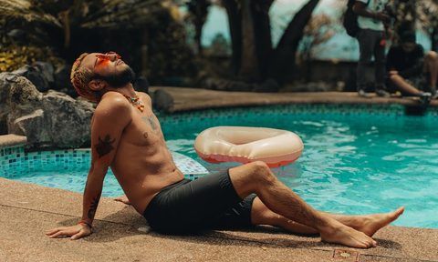 man relaxing in sun sunbathing