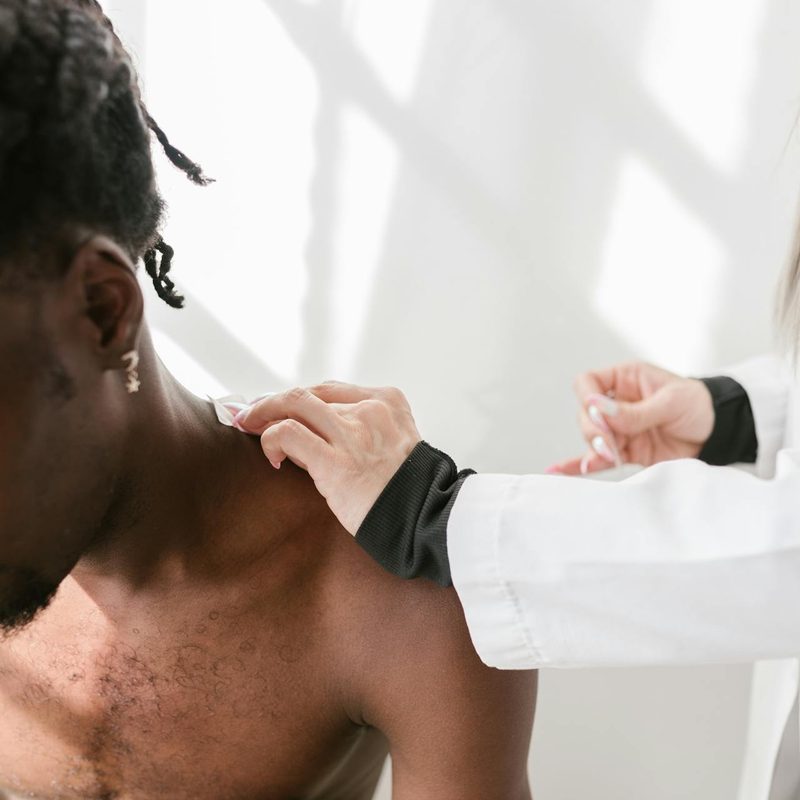 a man getting treated by a dermatologist