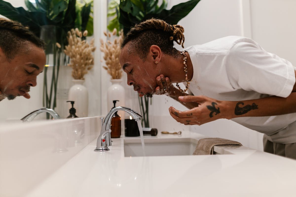 man washing face side angle