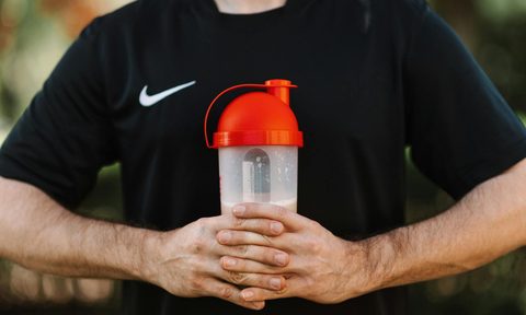 creatine protein shake man holding drink