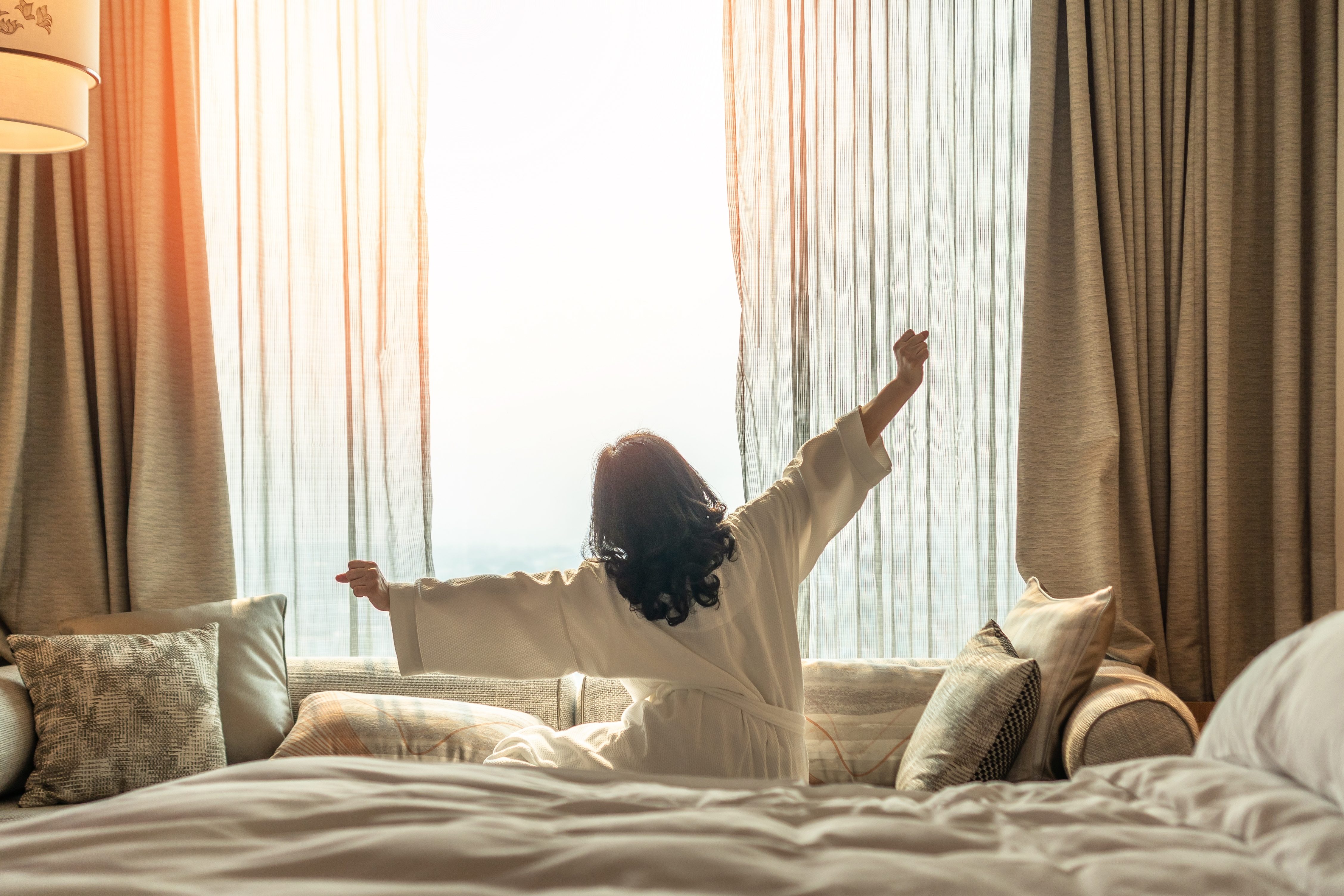 Woman waking up in hotel room