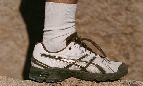 man wearing asics temptation vacation on rock