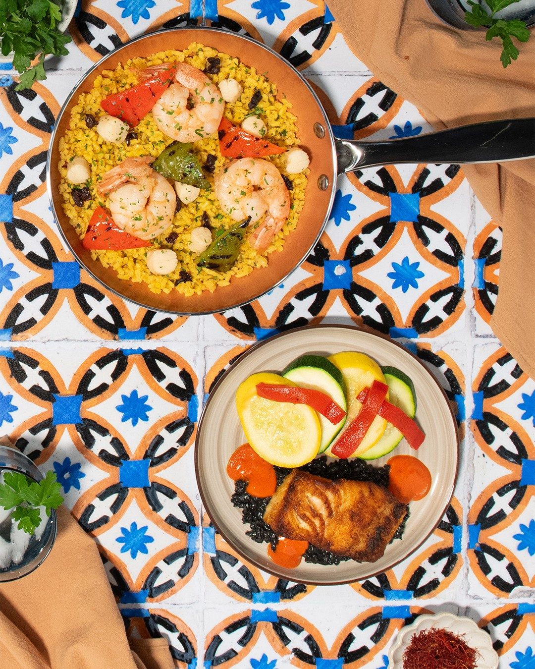 Spanish-inspired dishes: Mar y Mar paella and seared sea bass